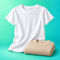 White cotton T-shirt and folded beige knit sweater on a mint turquoise background