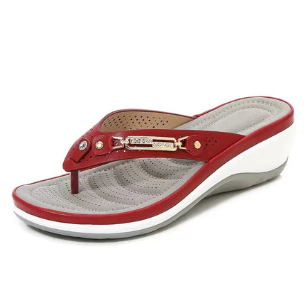 Side view of a red thong wedge sandal with a white sole
