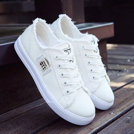 White frayed-edge canvas sneakers with closed backs