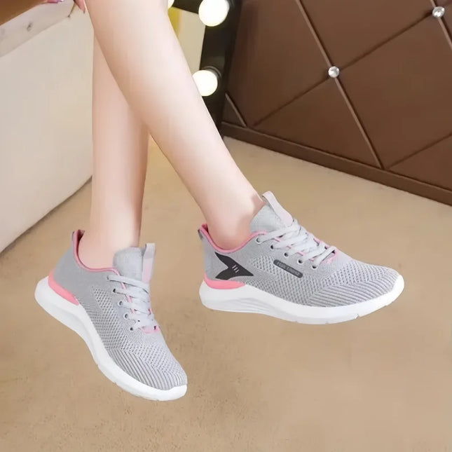 Woman wearing gray and pink lace-up running shoes