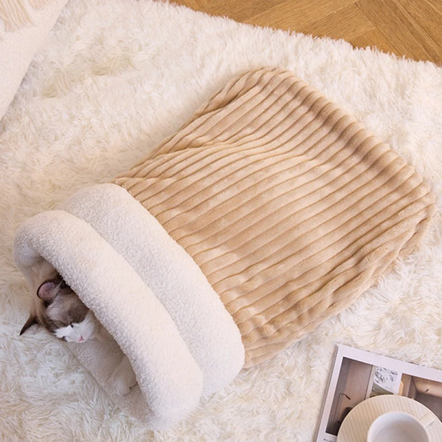 Top-down view of a cat sleeping in a brown corduroy sleeping bag