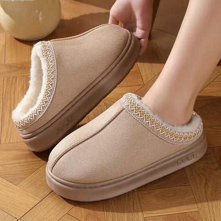Beige plush-lined slippers worn indoors beside a wooden chair