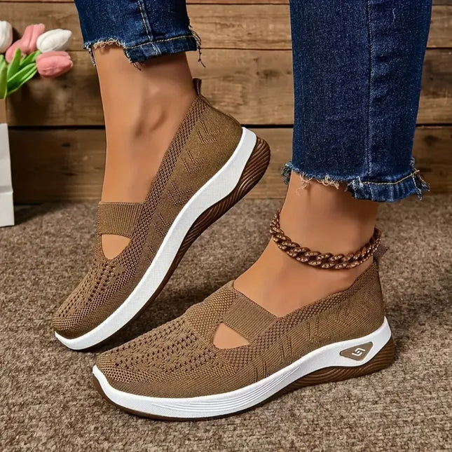 Brown cutout knit walking shoes with white soles, worn with jeans