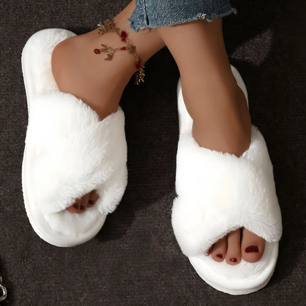 White plush crossband slippers worn with cropped jeans