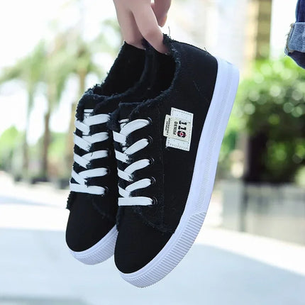 Black closed-back canvas sneakers with white laces and soles