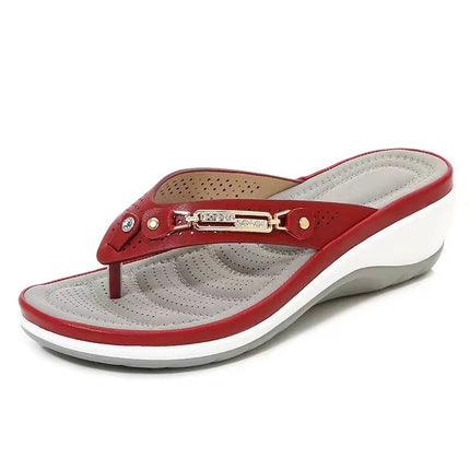 Red thong wedge sandal with metallic strap decoration and a gray footbed