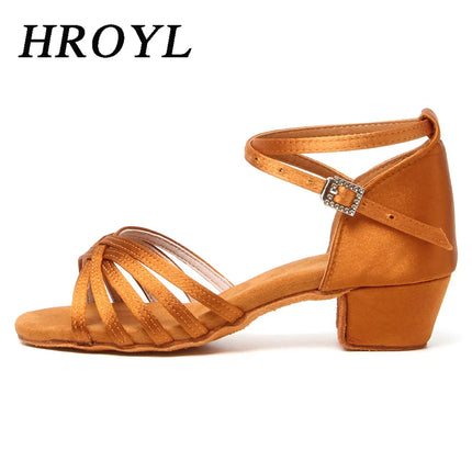 Side view of a tan satin ballroom dance shoe with a buckle ankle strap