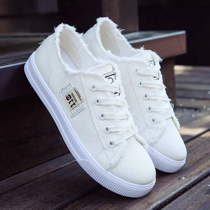White closed-back canvas sneakers with frayed trim