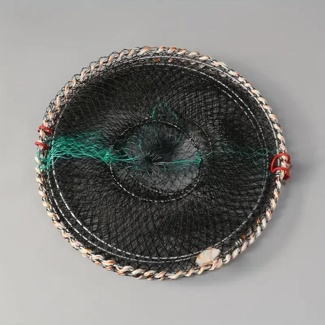Folded flat circular black fish trap on a grey background
