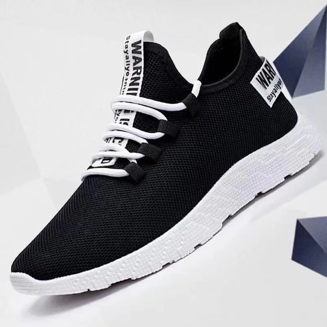 Black mesh sneaker with white sole and laces, side view