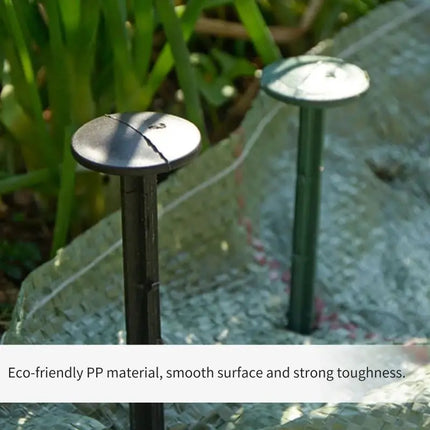 Plastic stakes securing garden fabric