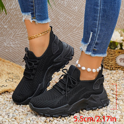 Side view of black chunky mesh sneakers with a sole-height annotation