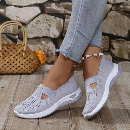 Light gray knit slip-on sneakers worn with cropped jeans