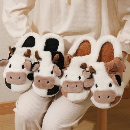 Black-and-white and brown-and-white plush cow slippers worn with light pants