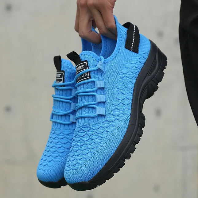 Hand holding bright blue knit sneakers