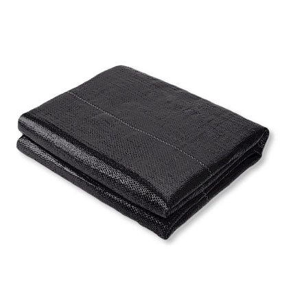 Folded black woven landscape fabric on a white background