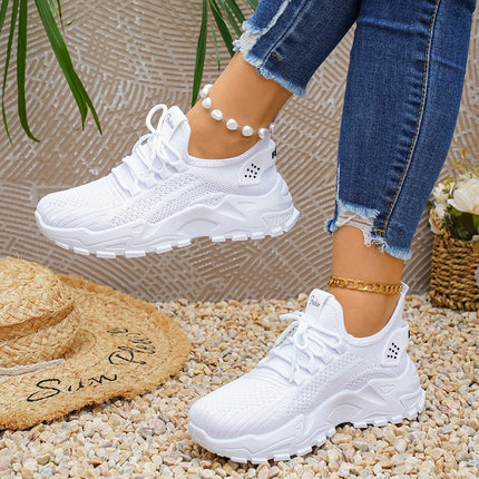 White chunky mesh sneakers worn with cropped jeans