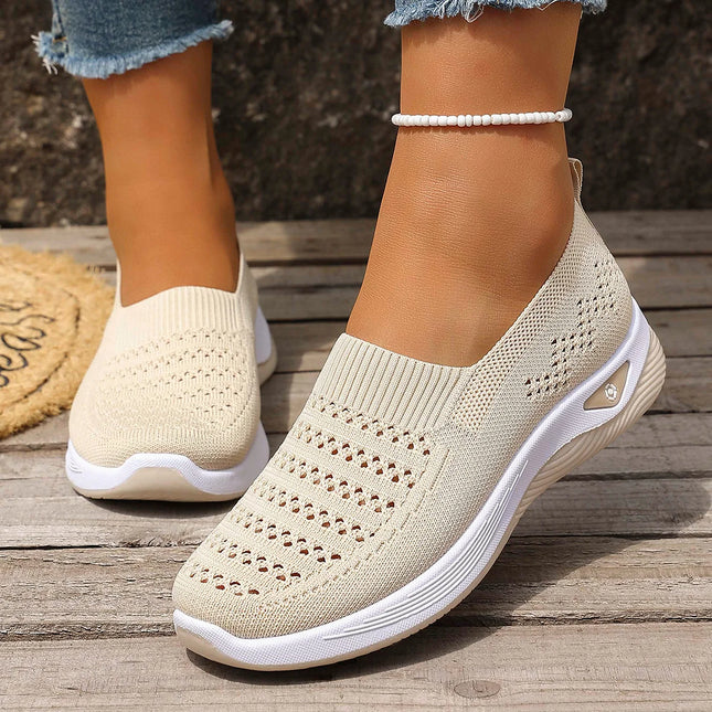 Woman wearing cream knit slip-on sneakers