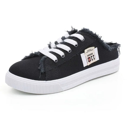 Black backless canvas sneaker with frayed edges