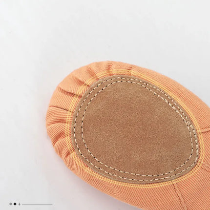 Close-up of the stitched sole pad on a canvas ballet slipper