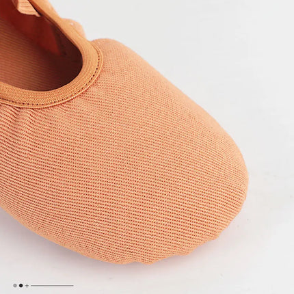 Close-up of the canvas toe on a tan ballet slipper