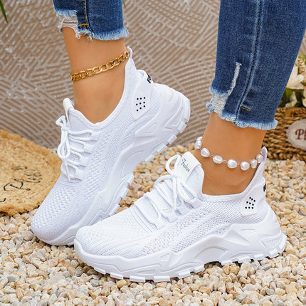White lace-up mesh sneakers showing the sculpted soles