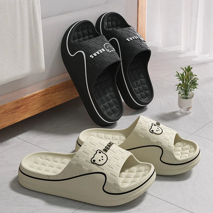 Black and cream cartoon bear slides displayed beside a window