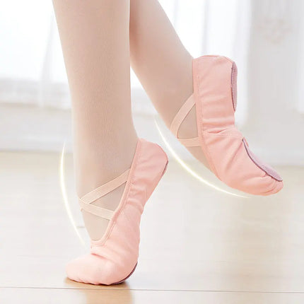 Pink canvas ballet slippers with crossed elastic straps, worn for dance practice