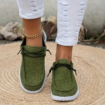 Green canvas lace-up loafers worn with white pants