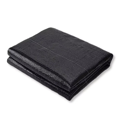 Folded black woven landscape fabric on a white background