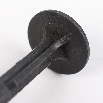 Close-up of a black nail head underside with rib supports
