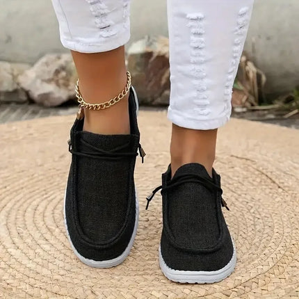 Black canvas lace-up loafers worn with white pants