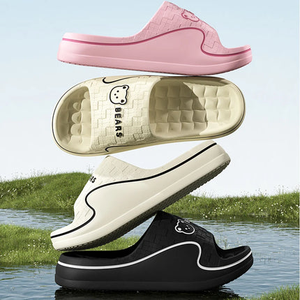 Pink, cream and black EVA slide slippers showing thick soles and textured footbeds