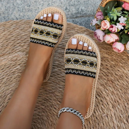 Top view of black boho slide sandals with gold-tone chain details