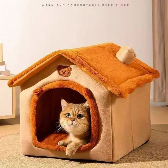 Orange plush house-style pet bed with a cat inside